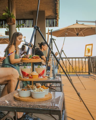 a man sitting on a table with food and drinks