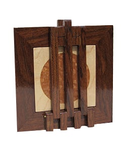 A lace-wood disc in the center of a maple square framed by wenge and overlayed by wenge bars