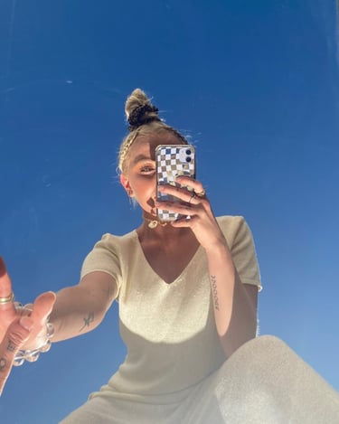 a woman taking a selfie with her phone social media manager