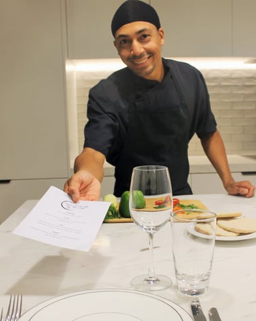 a man in a chef's uniform is holding a piece of paper