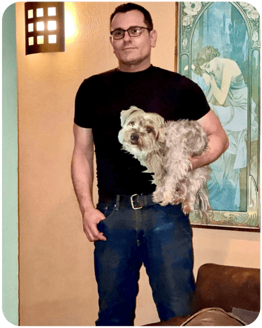 The artist Jason Marks holding Sparky his Yorkshire Terrier
