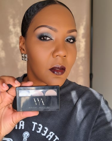 A woman showcases silver smokey eye makeup while holding a Wright Artistry eyeshadow palette.
