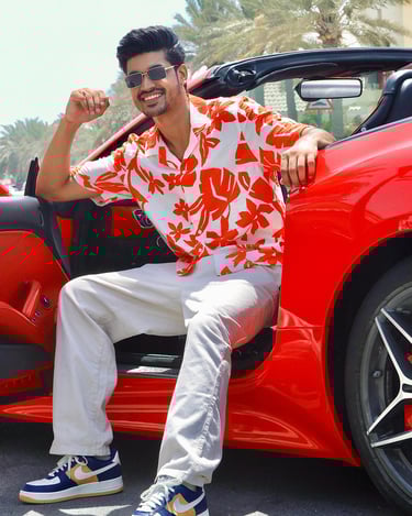 a man sitting in a red sports car