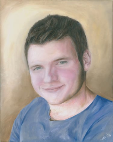 a portrait of a young man with a blue shirt
