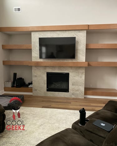 tv mounted on tile above a fireplace