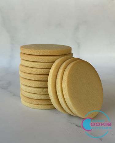 Stack of vanilla sugar cookies with three cookies on the side.