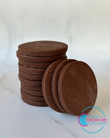 Stack of chocolate sugar cookies with three stacked on the side.