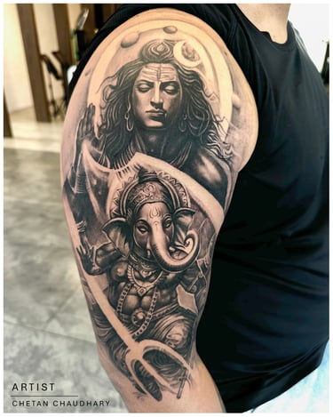 Photo of a religious shiva and ganesha tattoo on the bicep