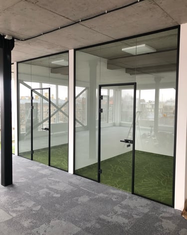 a large glass door with a green carpet