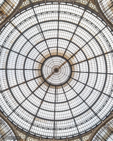 Glazed double arcade of the Galleria Vittorio Emanuele II in Milan, providing diffused daylight.