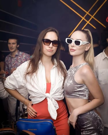 two women in sunglasses and sunglasses standing next to each other