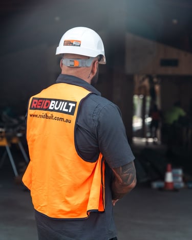 a man in a hard hat and safety vest