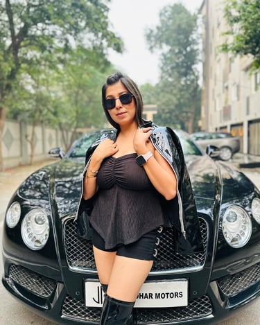 a woman in black shorts and boots is posing for a picture