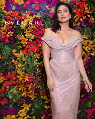 a woman in a pink dress standing in front of a floral wall