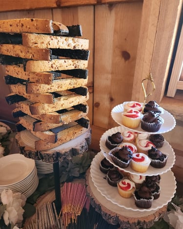 a tower of cupcakes with a stack of plates