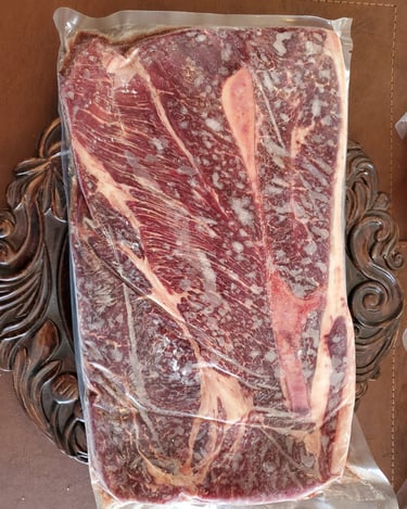 a piece of meat on a table with a knife and fork