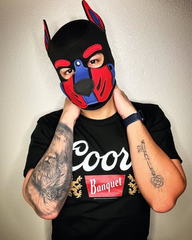 man in pup mas with tattoos