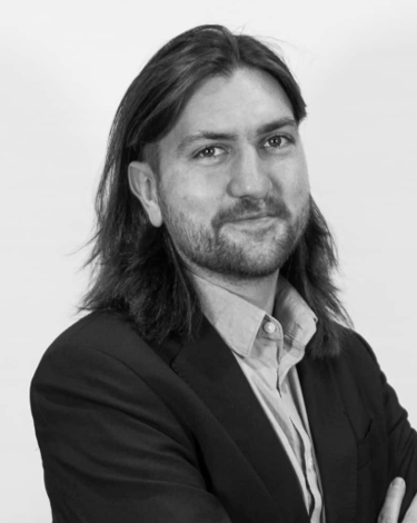 Expert in Blockchain with long hair and a beard and a watch on his wrist