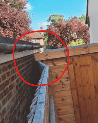 www.truthincontext.co.uk Displaced fence panels. posts and rainwater drains off from sloped roof