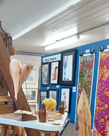 Our stall at the exhibition with paintings behind