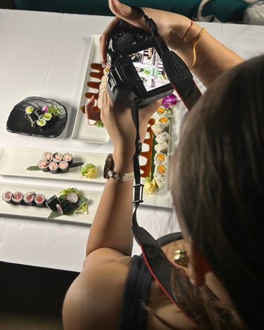 a woman is taking a picture of a sushi