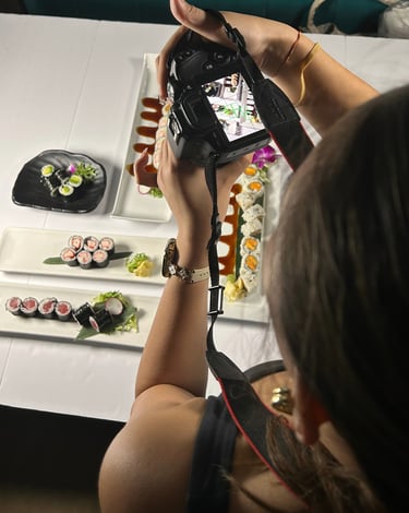 a woman is taking a picture of a sushi