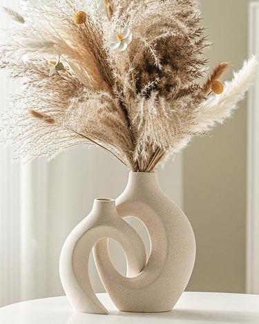 Modern ceramic vase set of 2 styled with dried pampas grass on a table, featuring neutral home decor in minimalist interior.