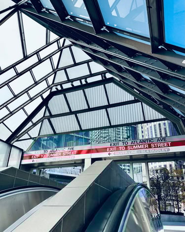 a train station with a sign that says, exit to Atlantic ave and exit to summer street