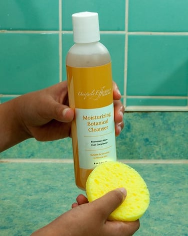 a person holding a moisturizing conditioner and a sp sponge pad