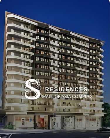 Modern high-rise exterior of S Residences luxury condominiums at the Mall of Asia Complex at night.