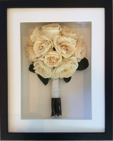 a simple white side view preserved wedding bouquet in a frame