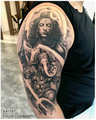 Photo of a religious shiva and ganesha tattoo on the bicep
