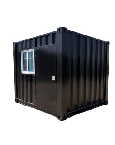 Black modified shipping container home with a glass window and steel door on a white background.