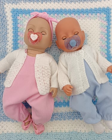 Zapf baby dolls dressed in pink and blue overalls