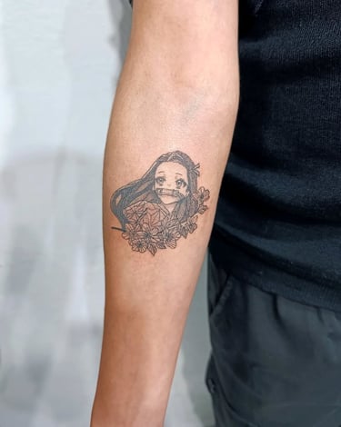 a man with a Nezuko tattoo on her arm