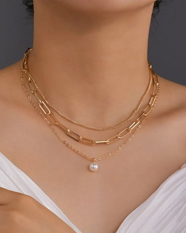 a woman wearing a white dress and a pearl necklace