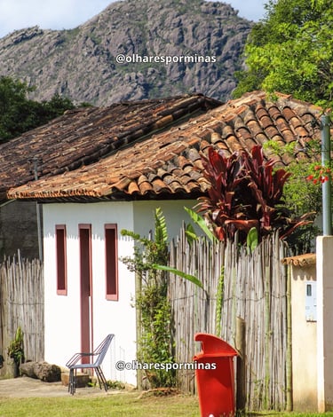 Casa tradicional com telhado colonial e montanhas ao fundo em Chapada, distrito de Ouro Preto MG