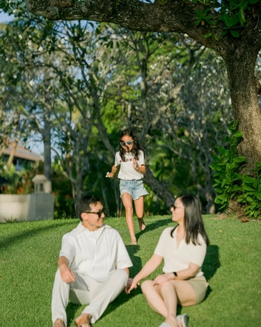 Child playing in the resort garden during a family photography session at InterContinental Bali Resort