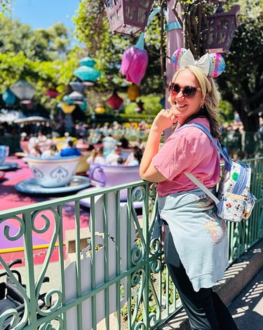 Emily Brisson pictured in front of the Mad Tea Party teacups at Disneyland® Park.