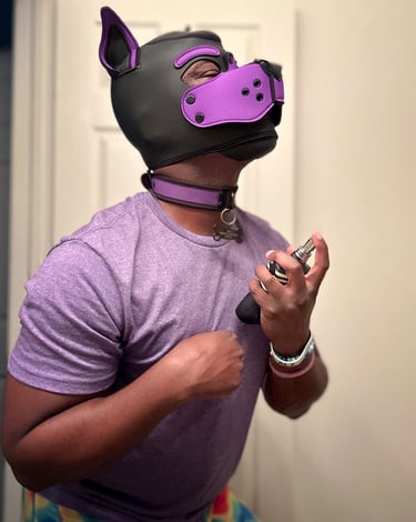 Man in a pup mask spraying on some perfume.