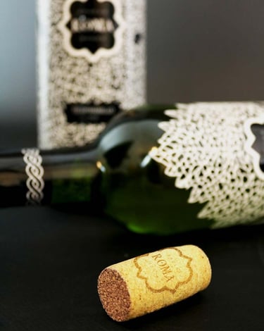Close up of two wine bottles and a cork