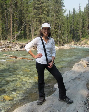 a person standing on a rock by the cascade river