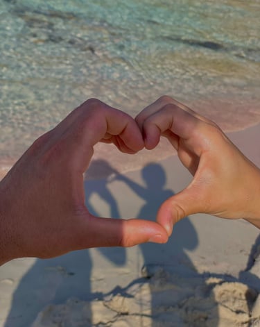 a person holding their hands in the shape of a heart