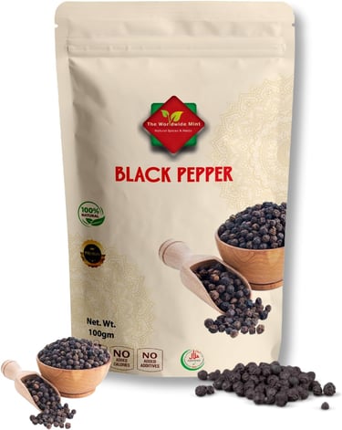 A 100g pouch of The Worldwide Mint organic black pepper whole corns with a wooden scoop and bowl.