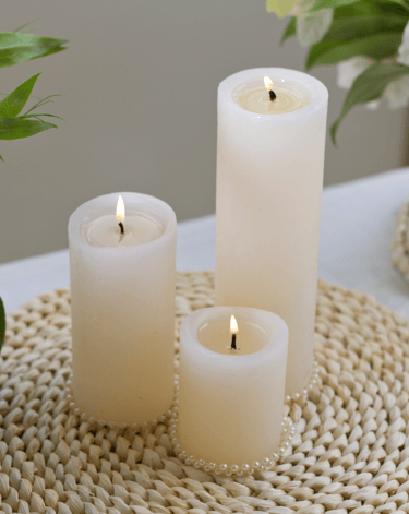 three candles are sitting on a table