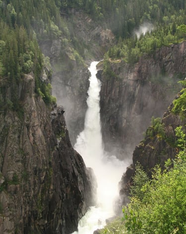 A tall waterfall in a gorge-Rjukan falls-wikimedia-cite