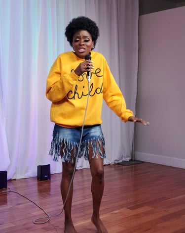 a woman in a yellow sweater and a microphone