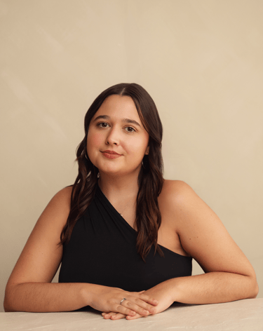 a woman in a black dress sitting at a table