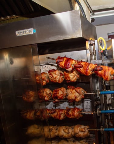 a man in a red shirt is holding a large rack with chicken