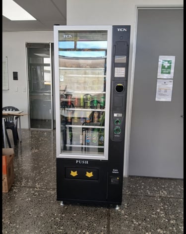 Commercial snack and drink vending machine installed at an Australian retail location.
